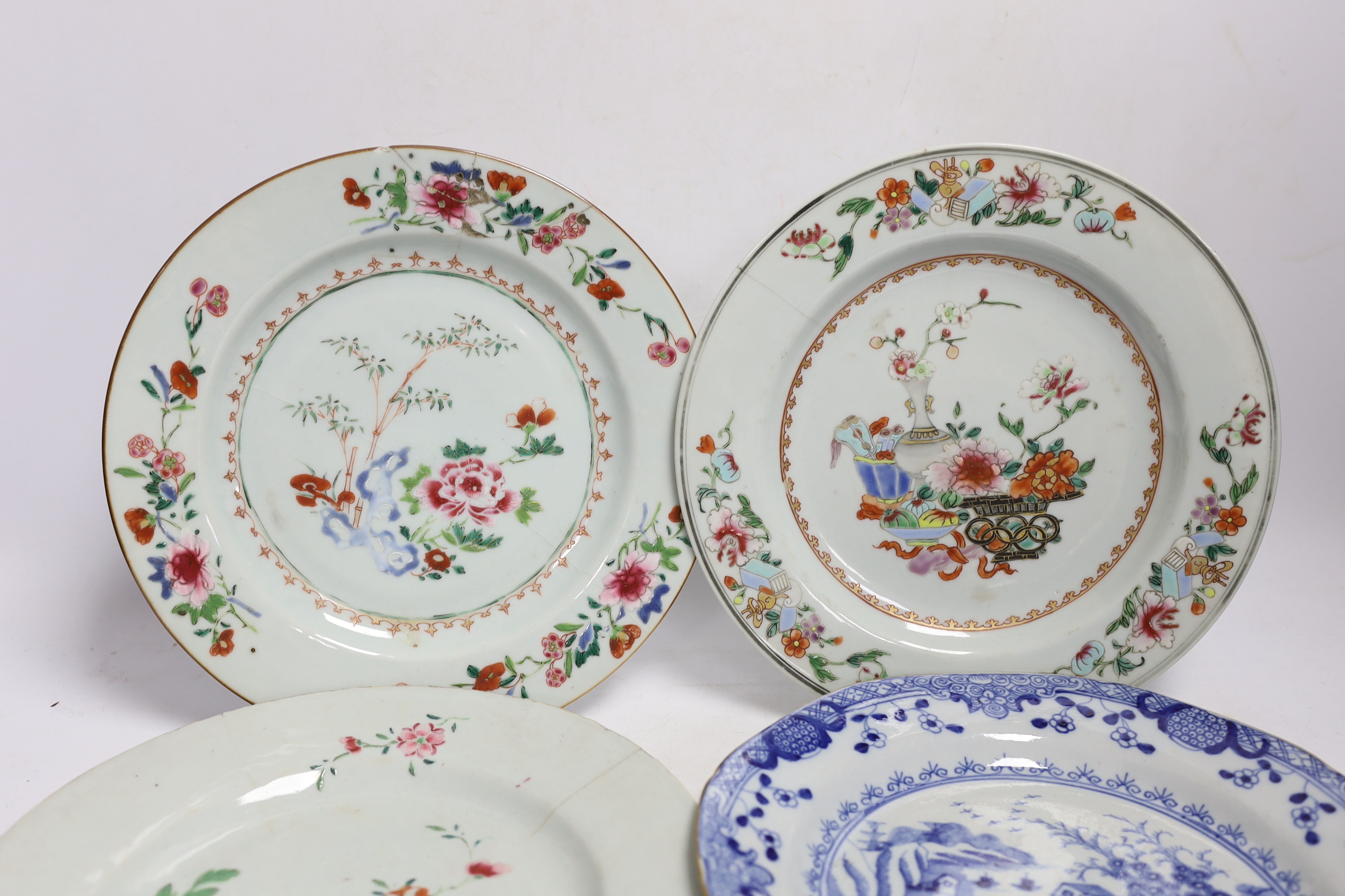 Four 18th century Chinese porcelain plates, and a later armorial plate, 21.5cm